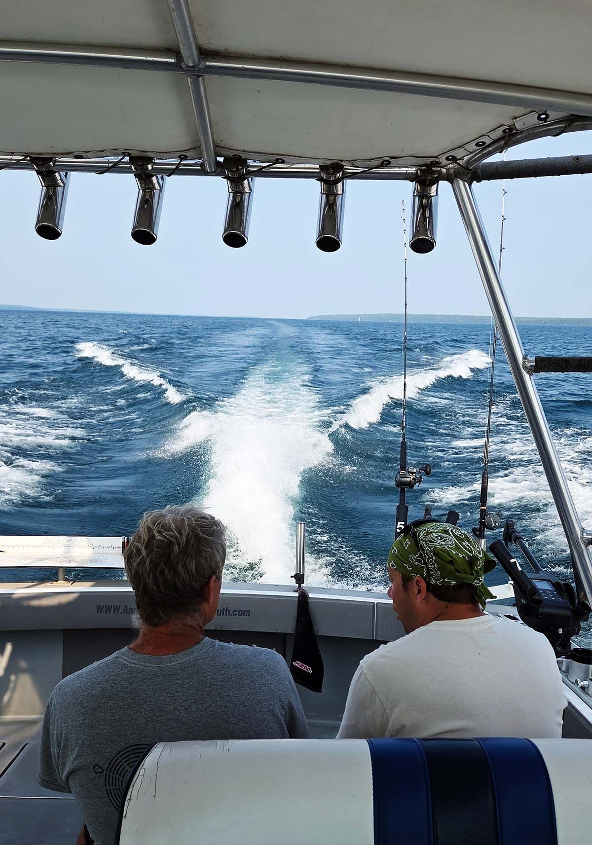 Sam Thayer and Alan Bergo chatting on a boat.