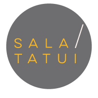 #descrevemospravocê  A imagem mostra o logotipo da Sala Tatuí, composto por um círculo de fundo cinza escuro. Dentro do círculo, centralizado, está o nome “SALA / TATUÍ” em letras maiúsculas e finas, na cor amarelo-mostarda. As palavras estão dispostas uma acima da outra, separadas por uma barra diagonal branca, que parte do canto superior direito da palavra "SALA" e se estende até logo acima da palavra "TATUÍ". O design é minimalista e moderno, com forte apelo visual e tipográfico, transmitindo uma identidade visual elegante e contemporânea.