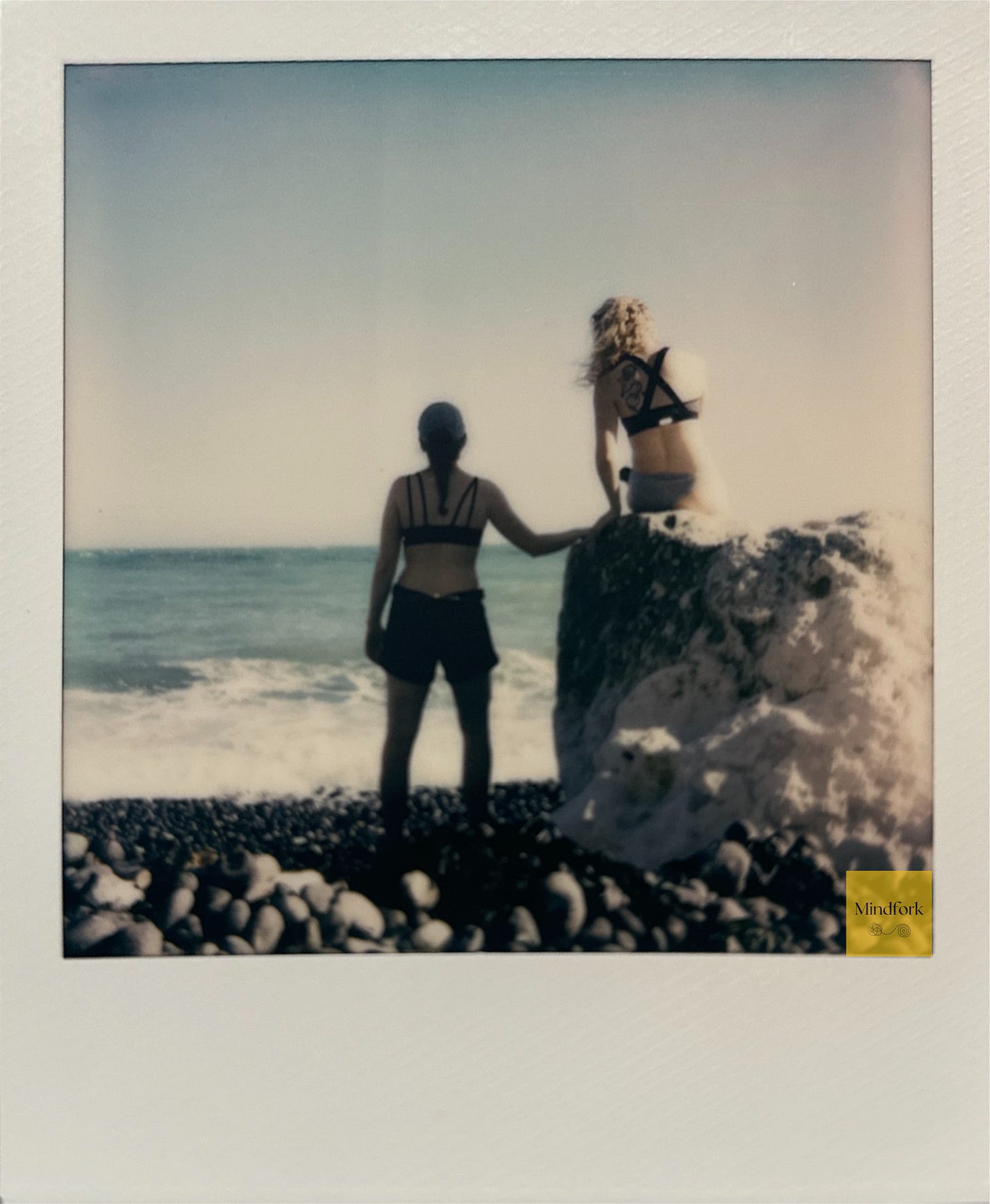 Two women looking out toward the sea