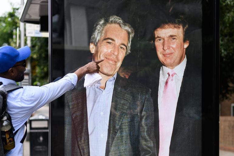LONDON, ENGLAND - JULY 17: A man gestures to a photograph of US President Donald Trump and convicted child sex offender Jeffrey Epstein after it is unofficially installed in a bus shelter on July 17, 2025 in London, England. The satirical artist behind the stunt has previously targeted Elon Musk and Tesla. The US president is facing criticism from his usually loyal Republican “Make America Great Again” (MAGA) supporters over suggestions that the administration is hiding details of Epstein’s crimes to protect the high profile figures he associated with, which included Trump. Having previously suggested that there was reason to investigate a rumoured list of clients, Trump has now refered to it as a hoax and called those calling for an investigation "weaklings". (Photo by Leon Neal/Getty Images)
