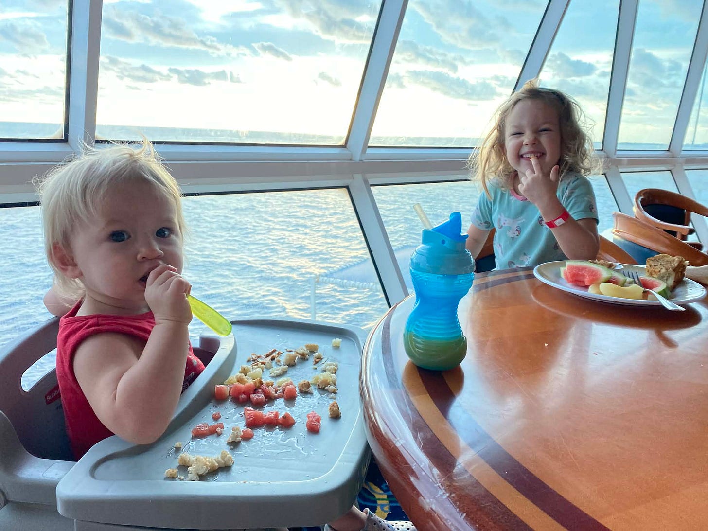 a baby and a toddler eat at the buffet on cruise ship