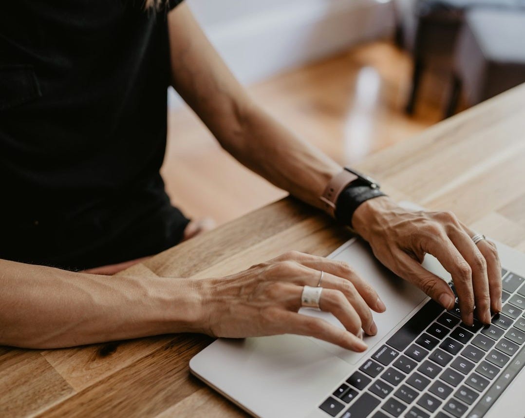 a person typing on a laptop