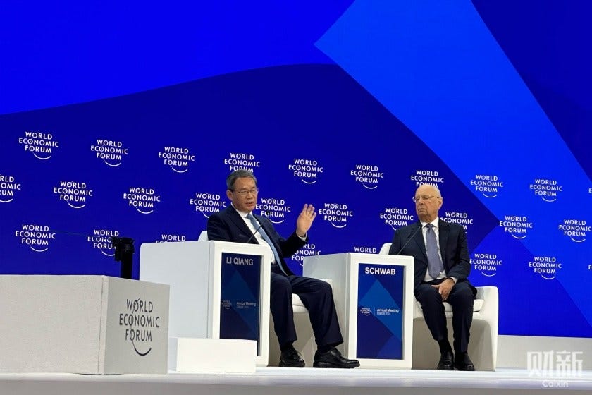 Premier Li Qiang speaks with World Economic Forum (WEF) founder and Executive Chairman Klaus Schwab on Tuesday on the sidelines of this year’s WEF annual meeting. Photo: Hu Shuli/Caixin