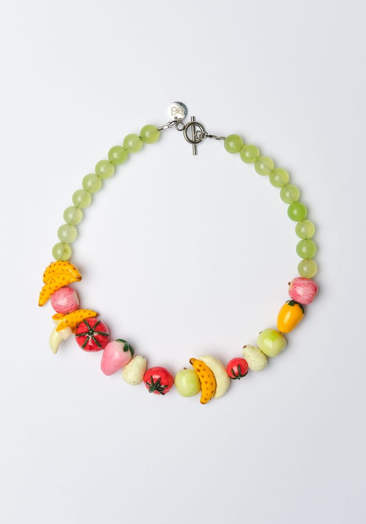 Photo One: multicolored stacking mugs.  Photo Two: a necklace with handmade fruit beads.