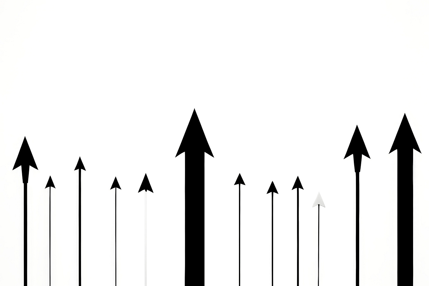 Magnifying glass examining performance data sheets to reveal underlying business patterns