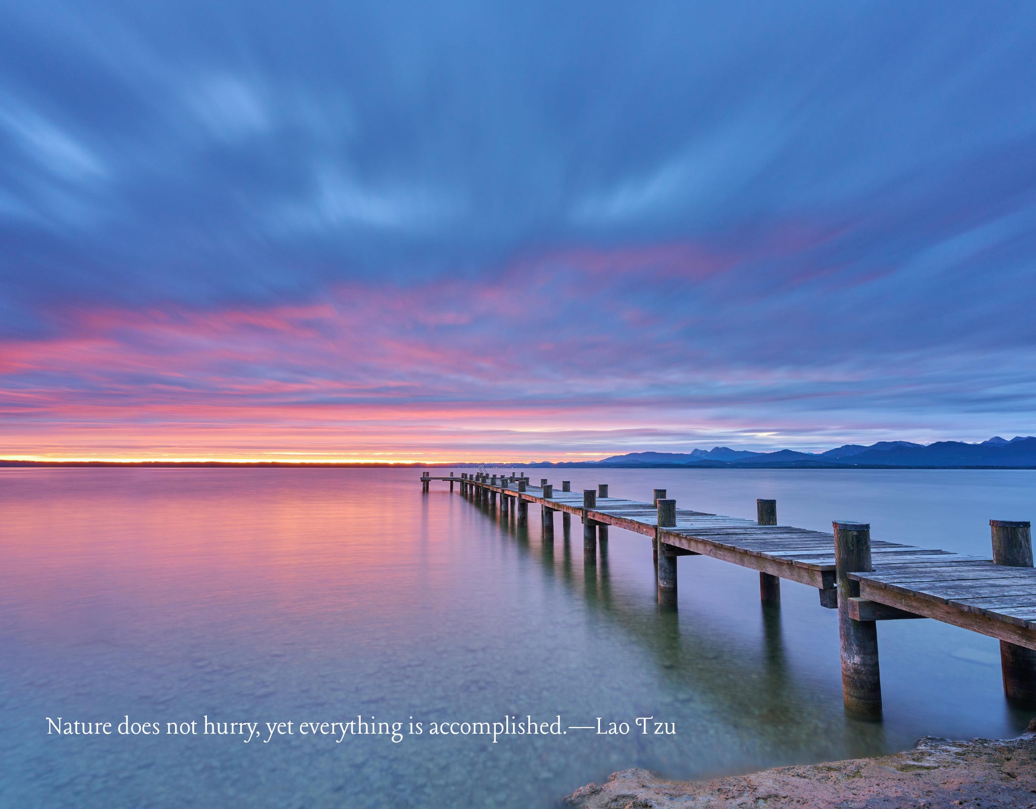 A tranquil wooden pier stretching into calm water beneath a pastel sunrise sky, symbolizing mindfulness, inner peace, and the natural rhythm of life. Flow, Don't Force: Trusting the Natural Rhythm of Life and Finding Inner Peace  Trust the rhythm already moving through your life, and notice how mindfulness deepens and joy begins to flow again