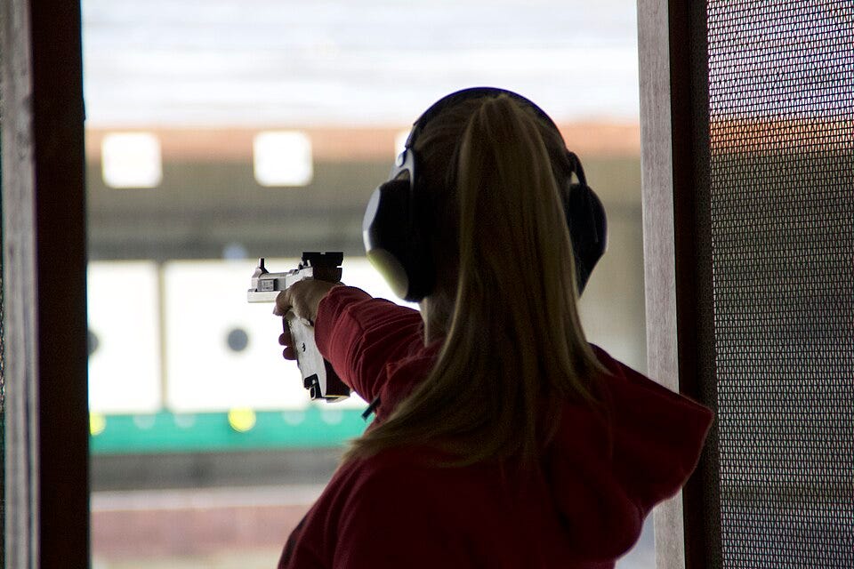 File:Female athlete fires an ISSF Sport Pistol.jpg