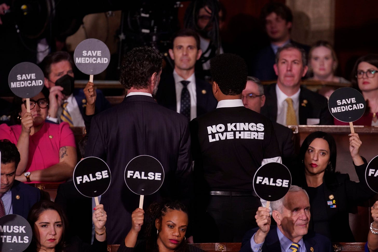 House Democrats hold signs in protest during a joint session of Congress in the House Chamber of the US Capitol in Washington, DC, US, on Tuesday, March 4, 2025. Donald Trump's primetime address Tuesday night from Capitol Hill.