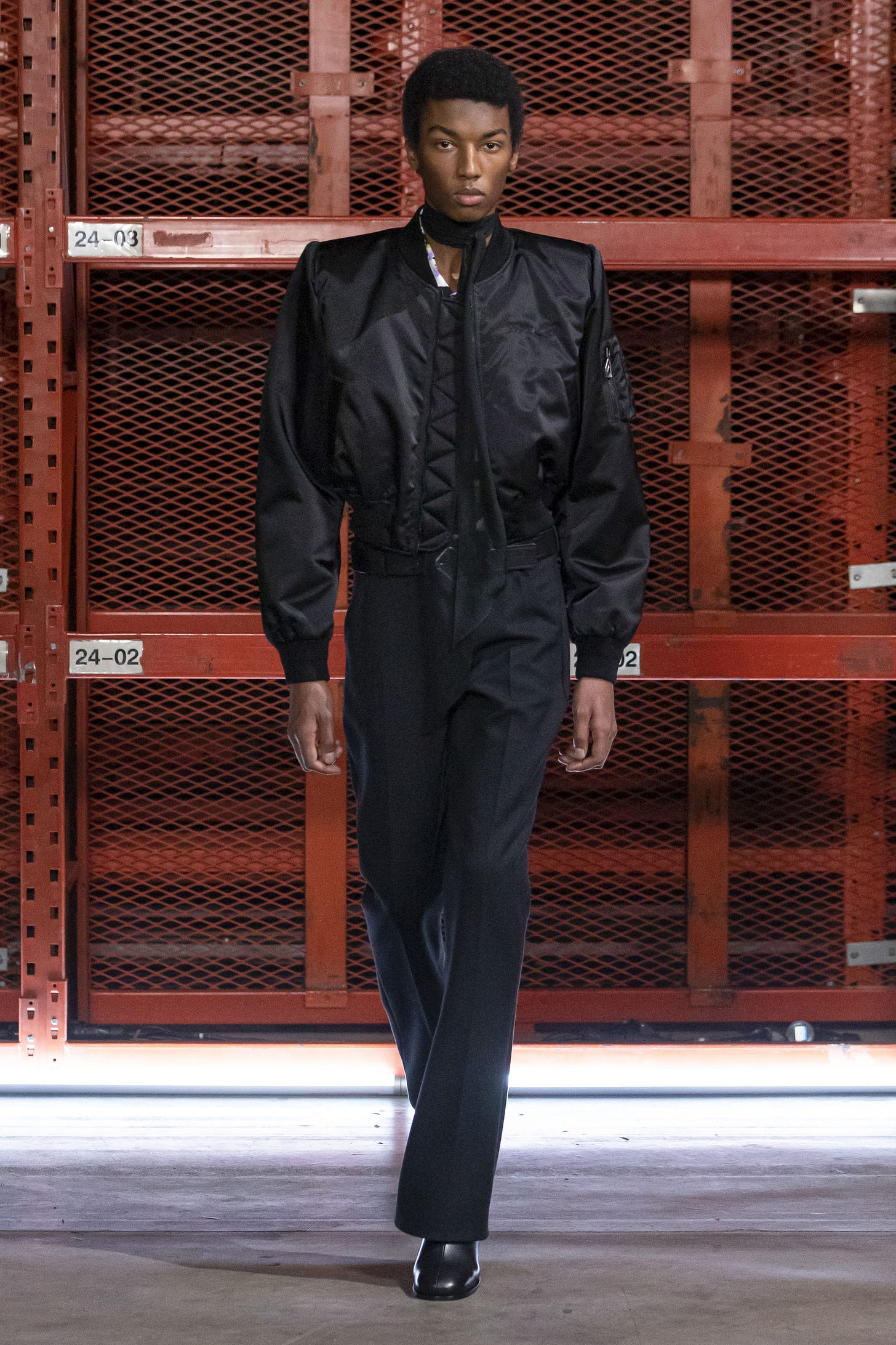 Image may contain Clothing Apparel Overcoat Coat Human Person Fashion and Suit