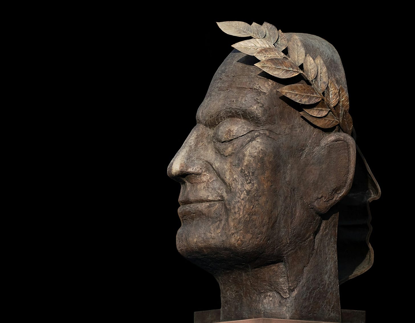 brown concrete statue of man