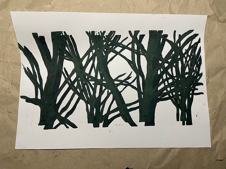 Photo's of overlapping linocut prints of trees in dark green ink.