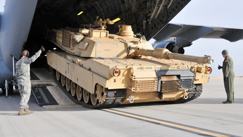 A M1A2 SEP (V2) Abrams Main Battle Tank being unloaded at Fort Carson's Arrival/Departure Airfield Control Group airfield.