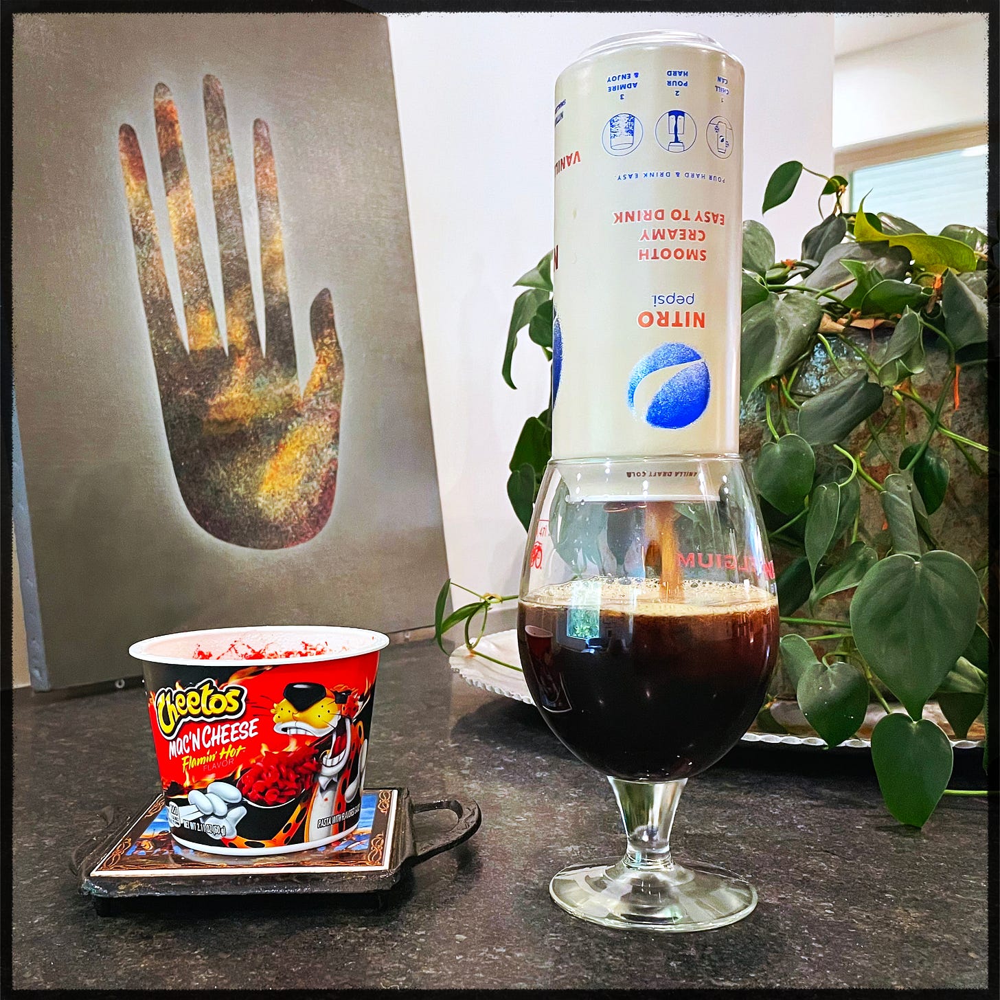 Cheetos and Pepsi on a counter.