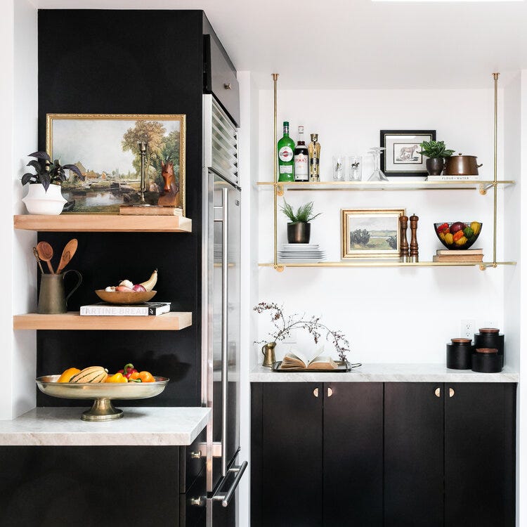 Room with white walls and black cabinets.