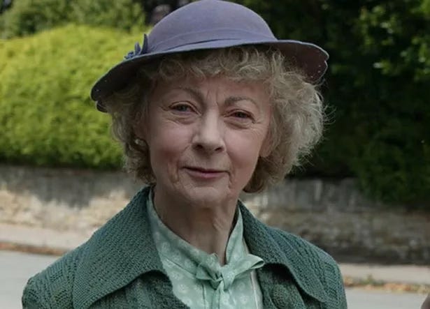 photo of an elderly woman wearing a hat