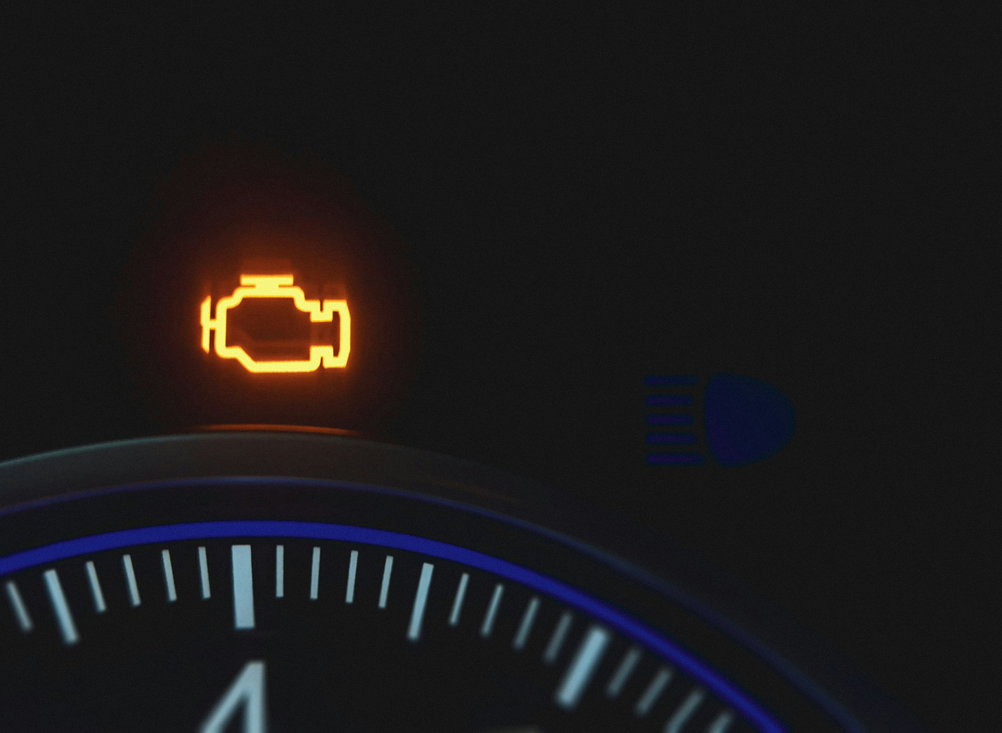 An engine warning light shines on a vehicle’s instrument panel