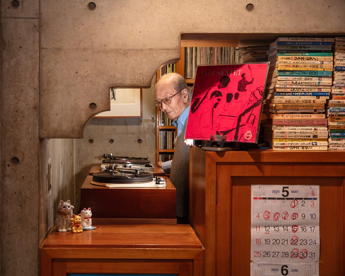 Elderly man in eyeglasses spinning a record. Elderly man in eyeglasses spinning a record.