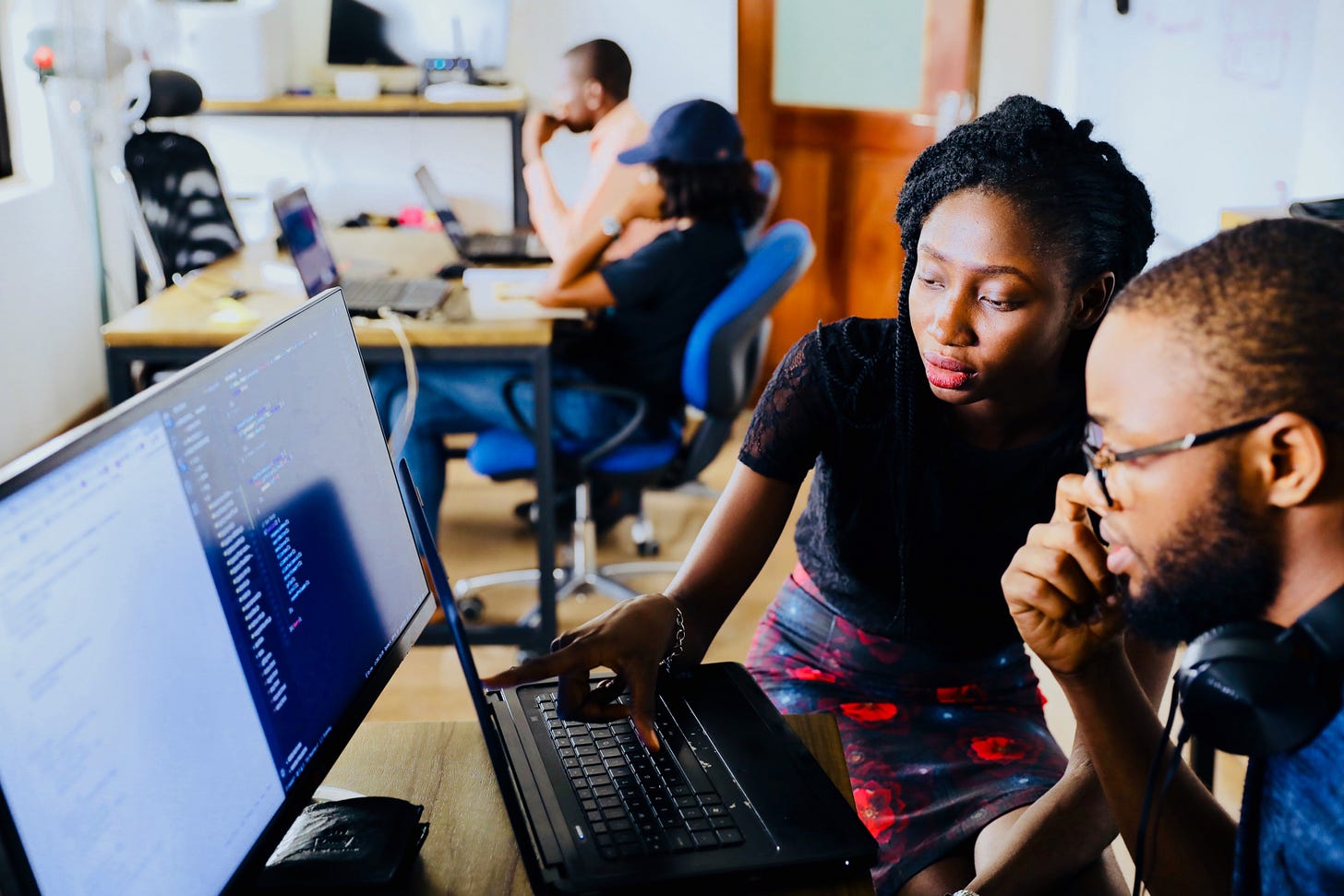 Two people looking at a computer Two people looking at a computer