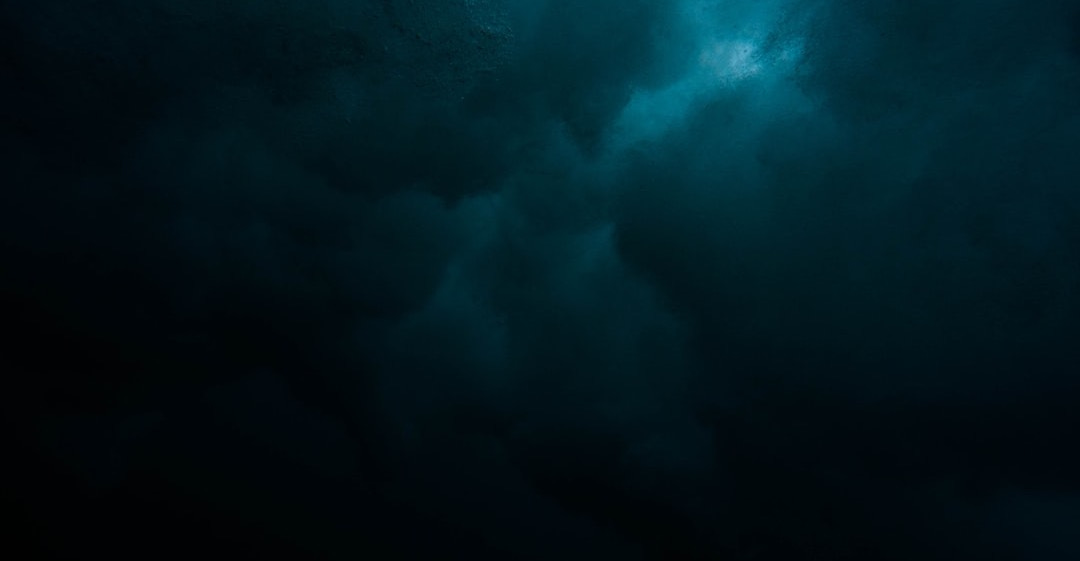 a large body of water under a cloudy sky