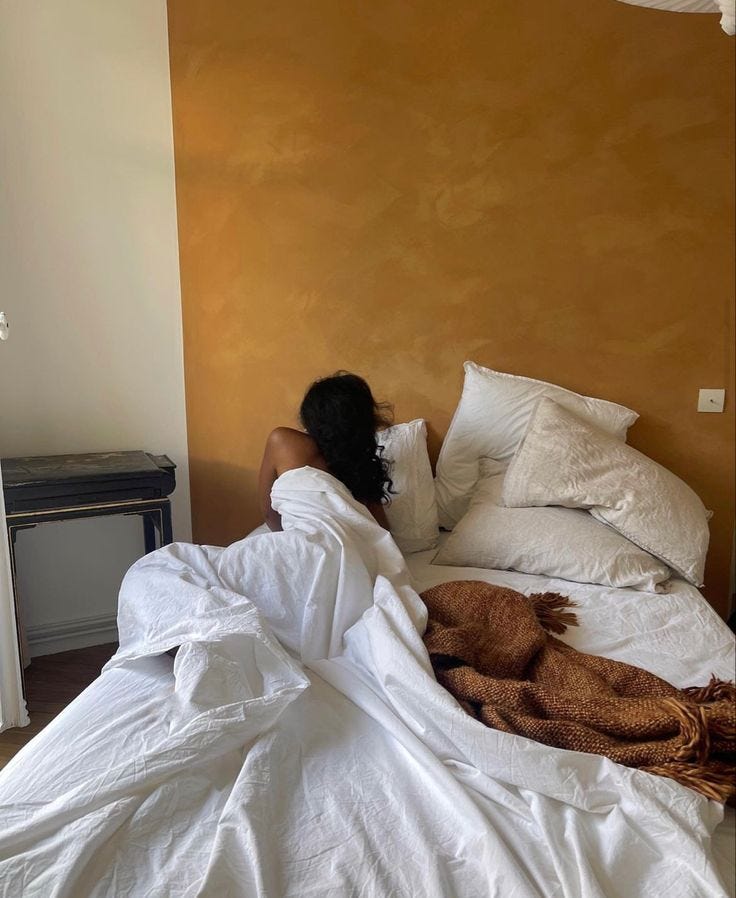 This may contain: a woman laying in bed with her head on the pillow This may contain: a woman laying in bed with her head on the pillow