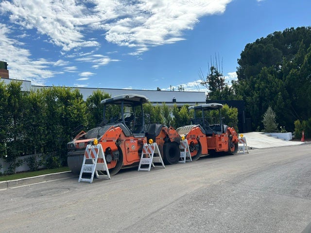 Street paving equipment along a road in Encino.