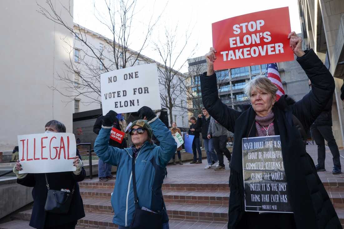 Demonstrators raise signs at a rally to protest the closing of the Consumer Financial Protection Bureau (CFPB) and the work-from-home order issued by CFPB Director Russell Vought outside its headquarters last month in Washington, D.C. Demonstrators raise signs at a rally to protest the closing of the Consumer Financial Protection Bureau (CFPB) and the work-from-home order issued by CFPB Director Russell Vought outside its headquarters last month in Washington, D.C.