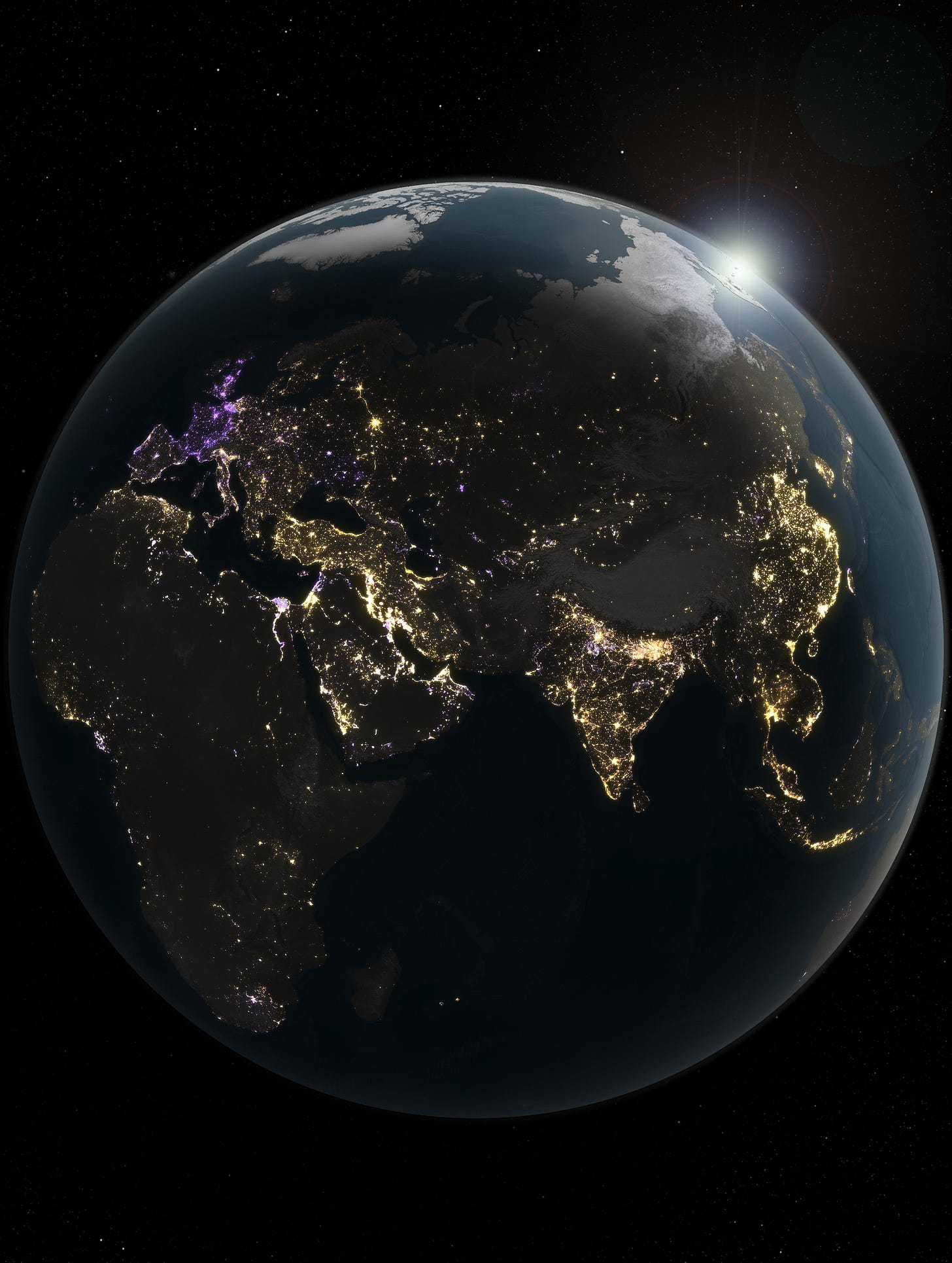 A view of Earth from space showing illuminated cities across Europe, Africa, and Asia at night, with the sun rising at the top right edge.