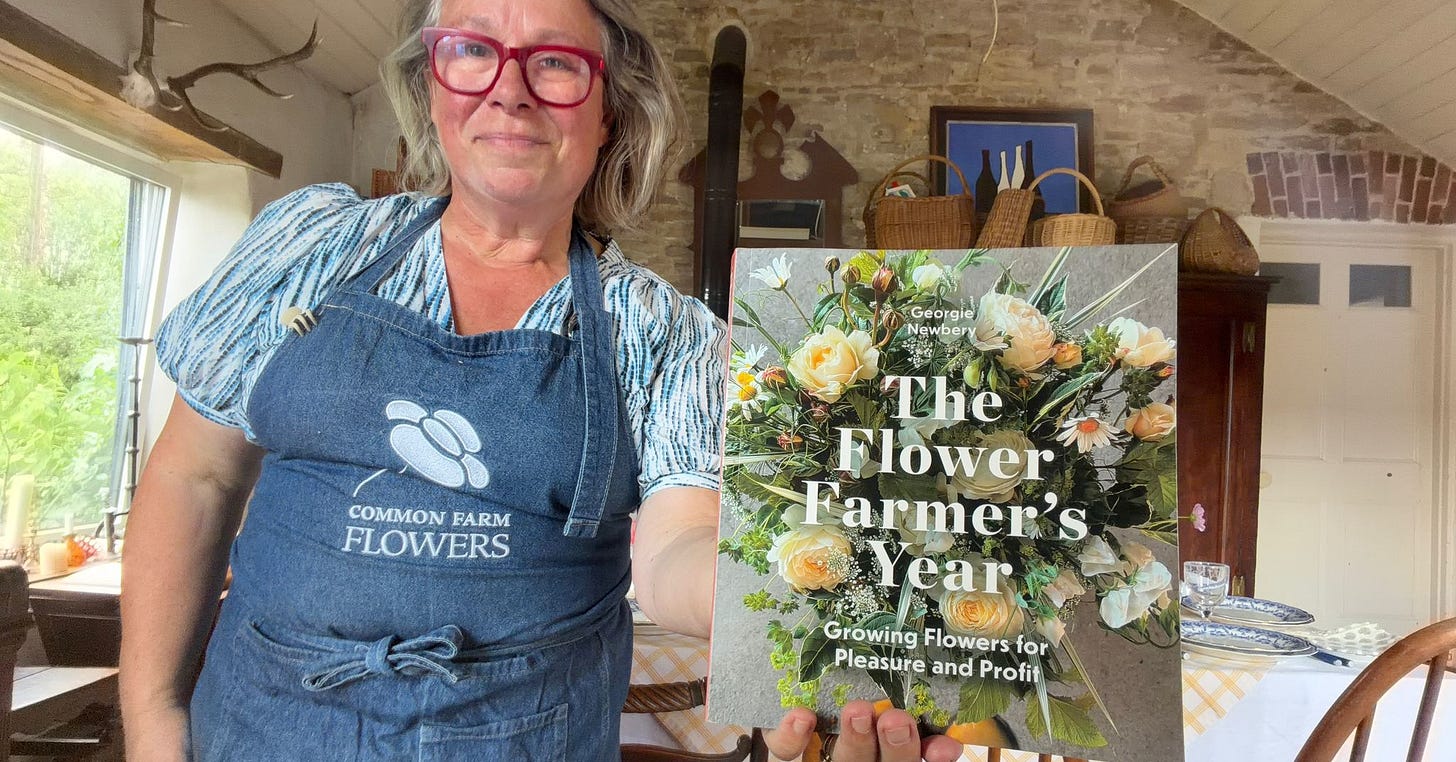 Flower farmer Georgie Newbery holds a copy of her new book The Flower Farmer's Year