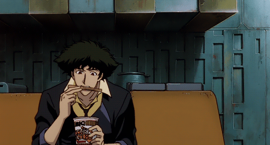 This may contain: a man sitting at a table with a drink in his hand