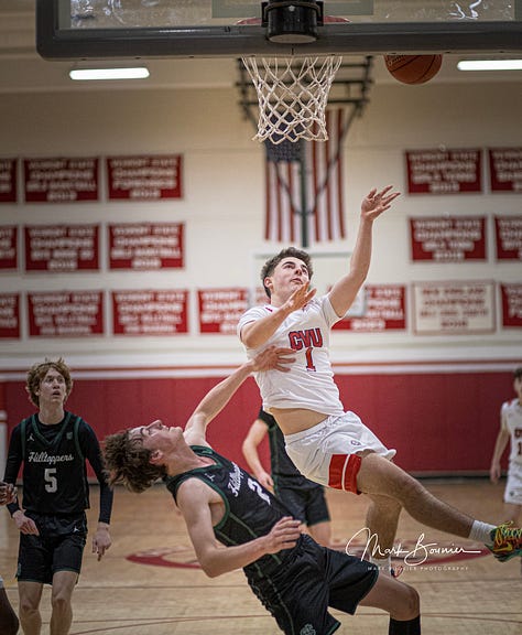 Five pictures of CVU boys basketball players in various stages of leaping and shooting with the ball. White uniforms with red lettering.