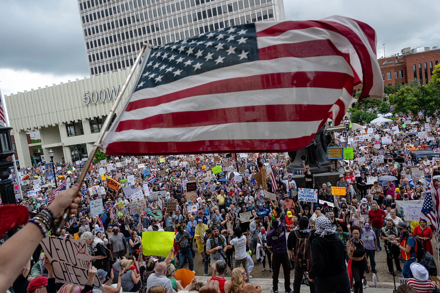 A person waves an American flag as demonstrators gather in Louisville, Kentucky.