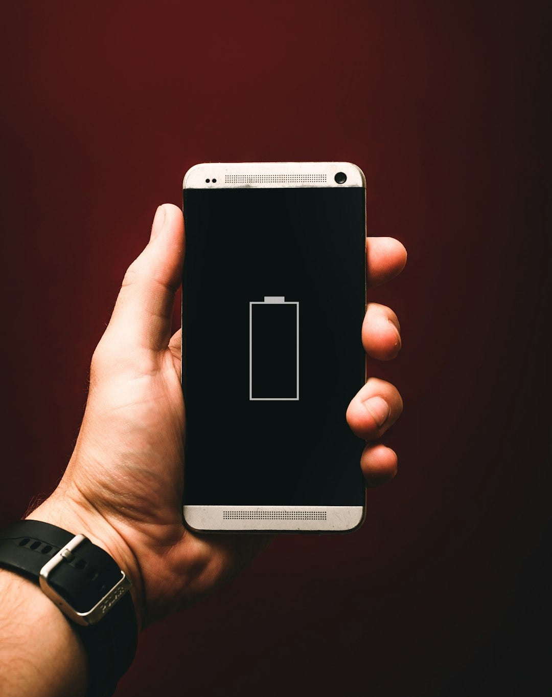 person holding low battery smartphone person holding low battery smartphone