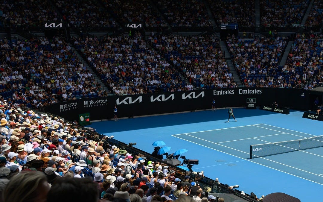 May be an image of tennis, crowd and text