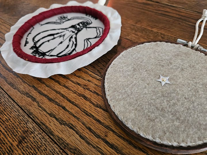 the backs of two embroideries, one left "open" and the other "finished" with felt
