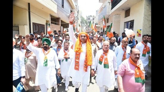 BJP Chandigarh candidate Sanjay Tandon during a foot march in Chandigarh on Sunday. (HT photo)