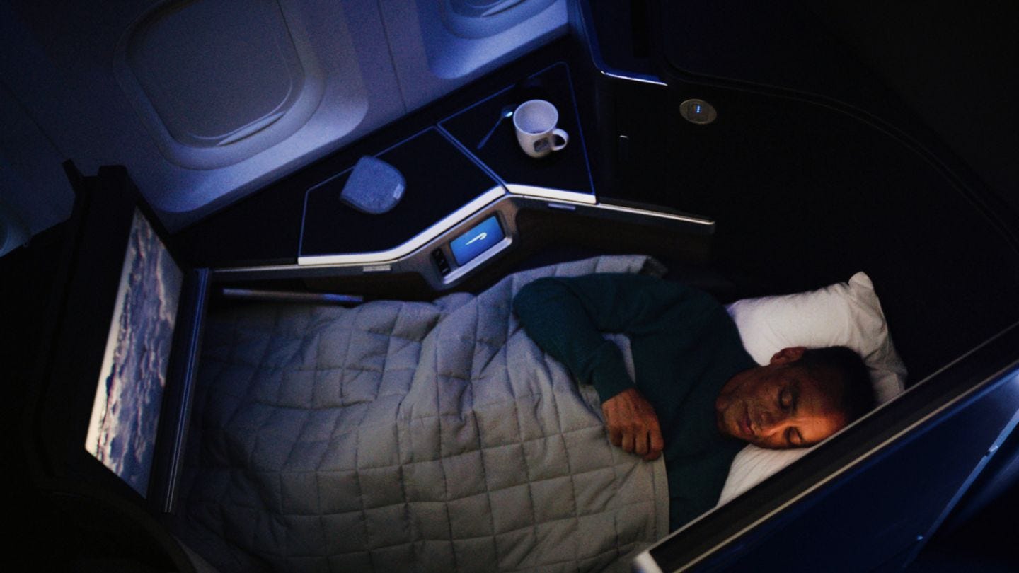 Man in lie down airlines seat