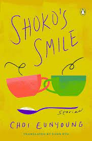 Cover of Shoko's Smile. Lemon yellow background. Graphics of red and green cups from which vapour arises. There is a violet spoon in which is probably sugar. Above these images, the words Shoko's Smile are written. And below, the name of the author, Choi Eunyoung.