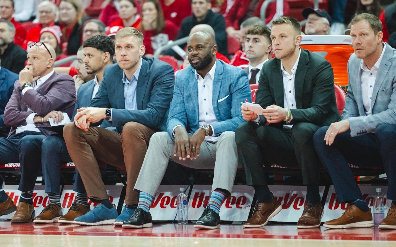 Wisconsin Badgers assistant coach Sharif Chambliss sits on the bench with other men’s basketball coaches during a game. Wisconsin Badgers assistant coach Sharif Chambliss sits on the bench with other men’s basketball coaches during a game.