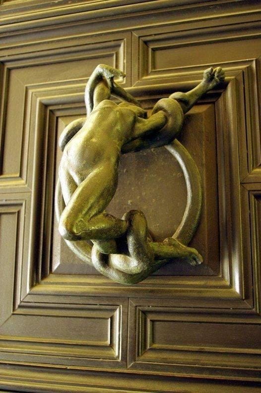 A pair of metal door knockers featuring a female and male nude figure, in sexual ecstasy, and in the embrace of a snake.