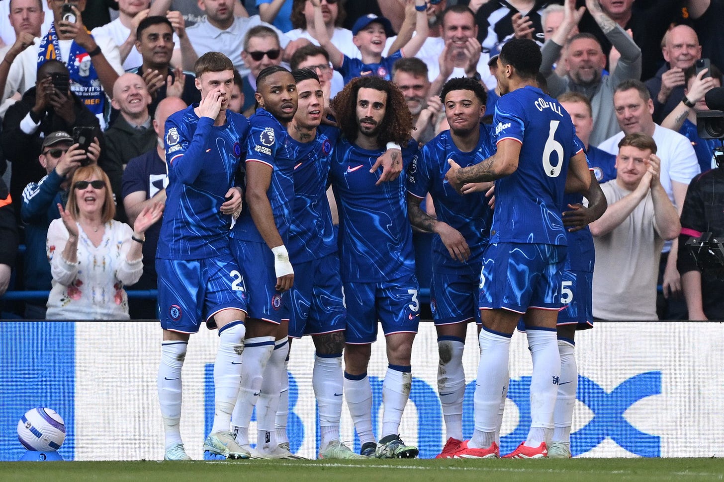 A Chelsea generic group huddle celebration.