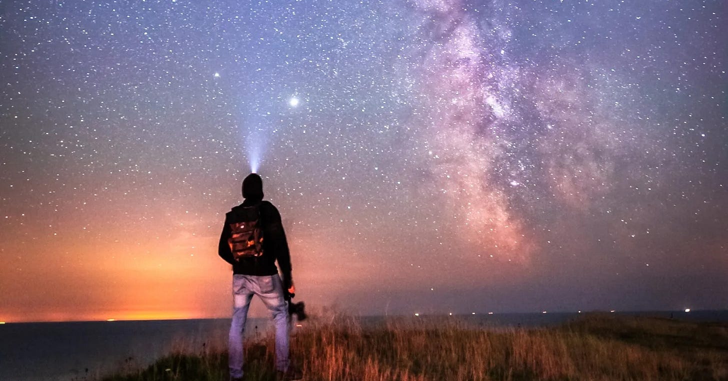 Man looking at starry sky