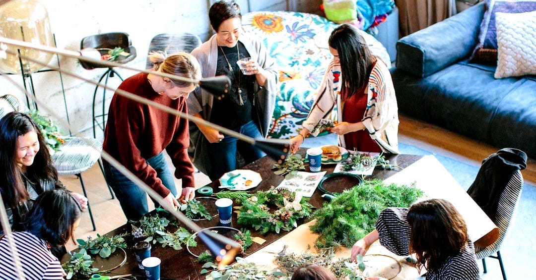 woman sitting on chair holding leaf