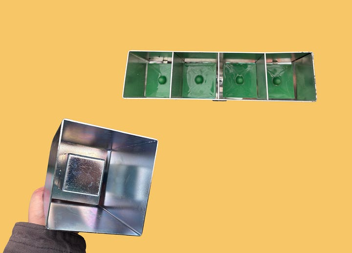 Soil blocking tools with varying divot sizes for seed starting and nesting pepper seedlings into larger blocks.
