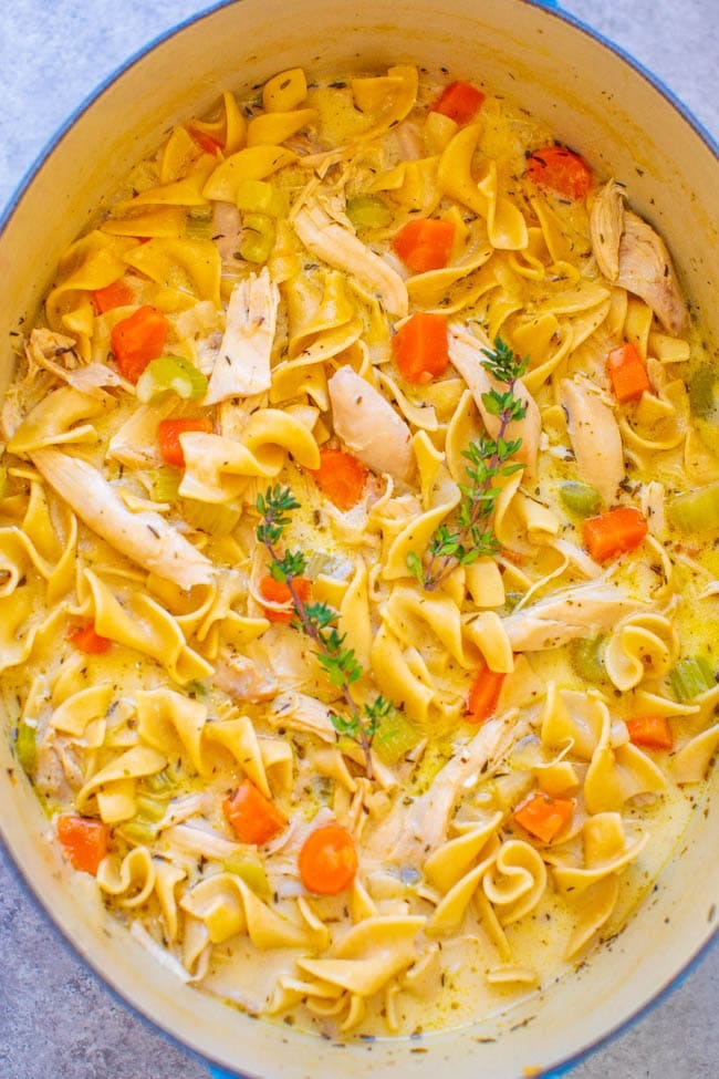overhead view of creamy chicken noodle soup in a large dutch oven overhead view of creamy chicken noodle soup in a large dutch oven