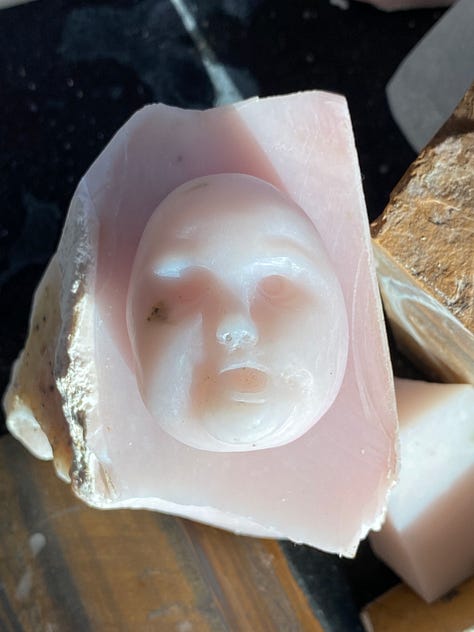 man carved out of pink opal