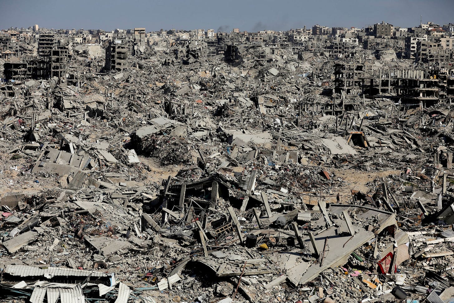 Palestinians make their way past the rubble of destroyed houses and buildings in Jabalia Palestinians make their way past the rubble of destroyed houses and buildings in Jabalia