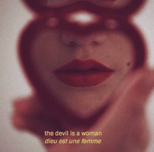 heart shaped mirror with woman's reflection and text reading the devil is a woman heart shaped mirror with woman's reflection and text reading the devil is a woman