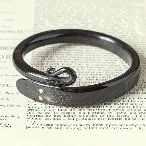 Stylized snake forms beginning in horn or shell are remade in early plastic approximations of natural materials.