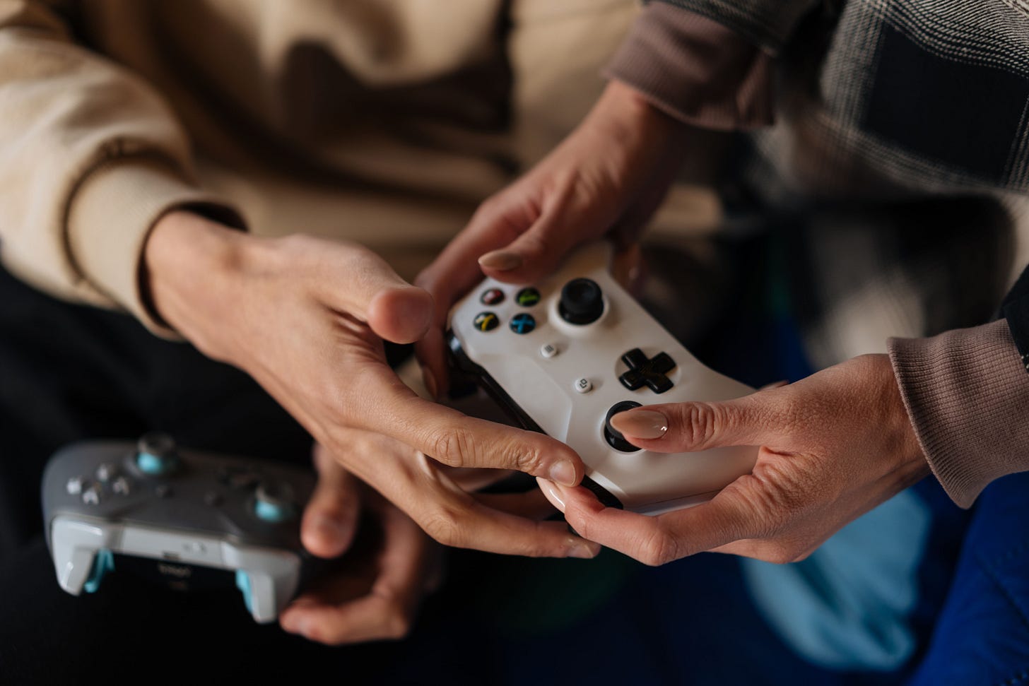 Two People Using Gaming Controllers · Free Stock Photo