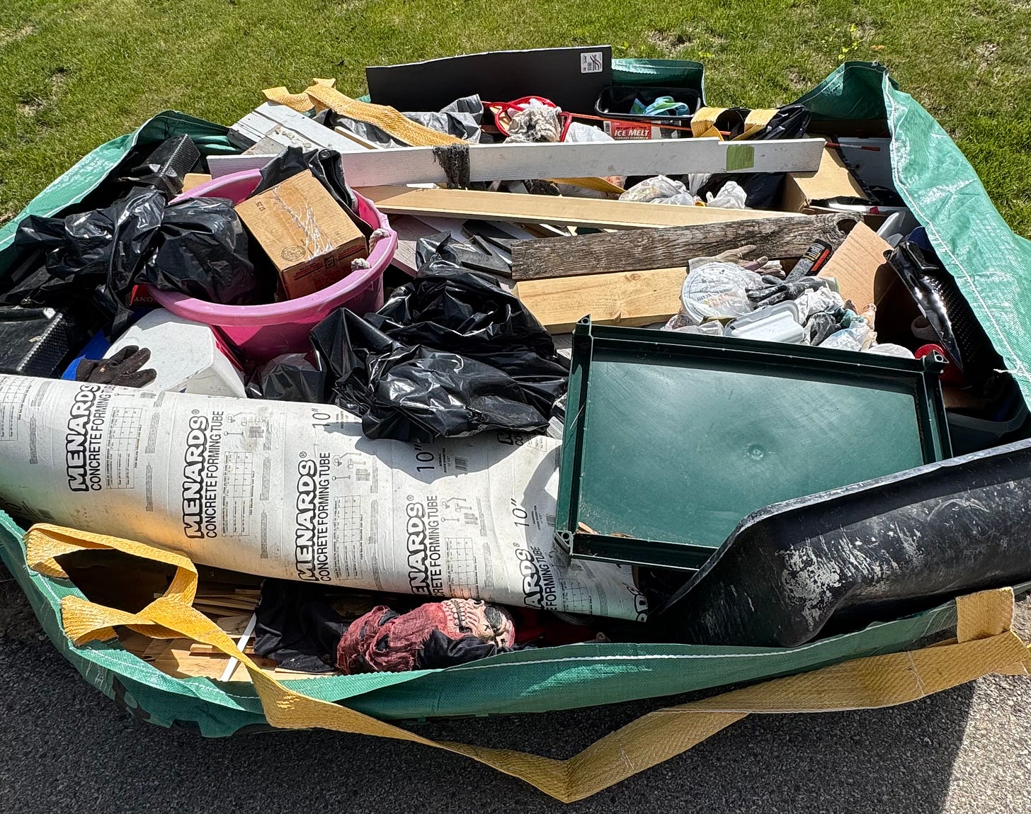A curbside Bagster filled with garbage